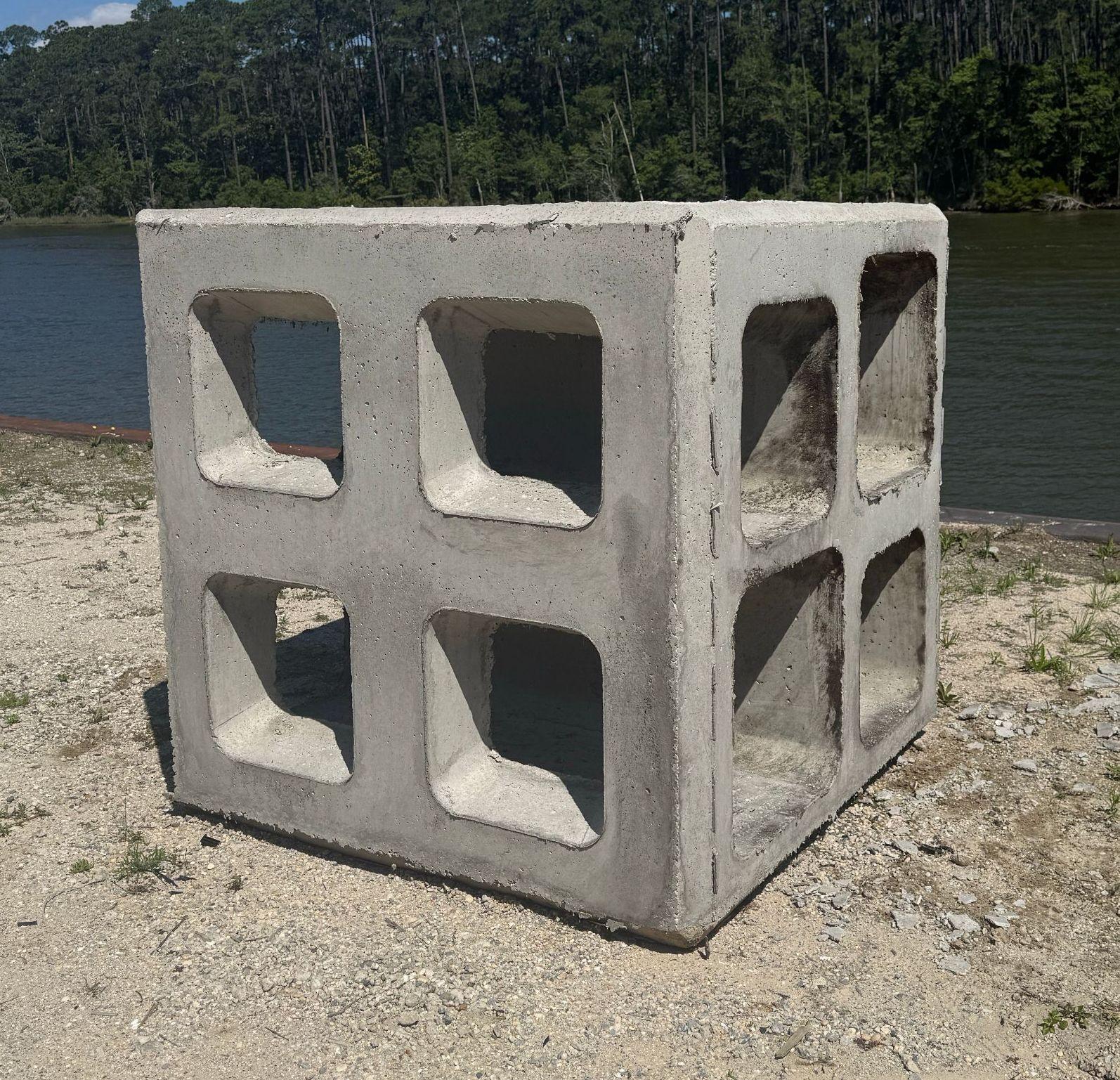 Side view of a concrete Marine Matrix reef module showing openings on multiple faces