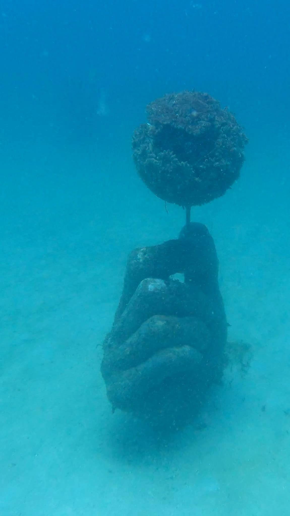 Let’s Not Blow This underwater dandelion sculpture by Kevin Reilly