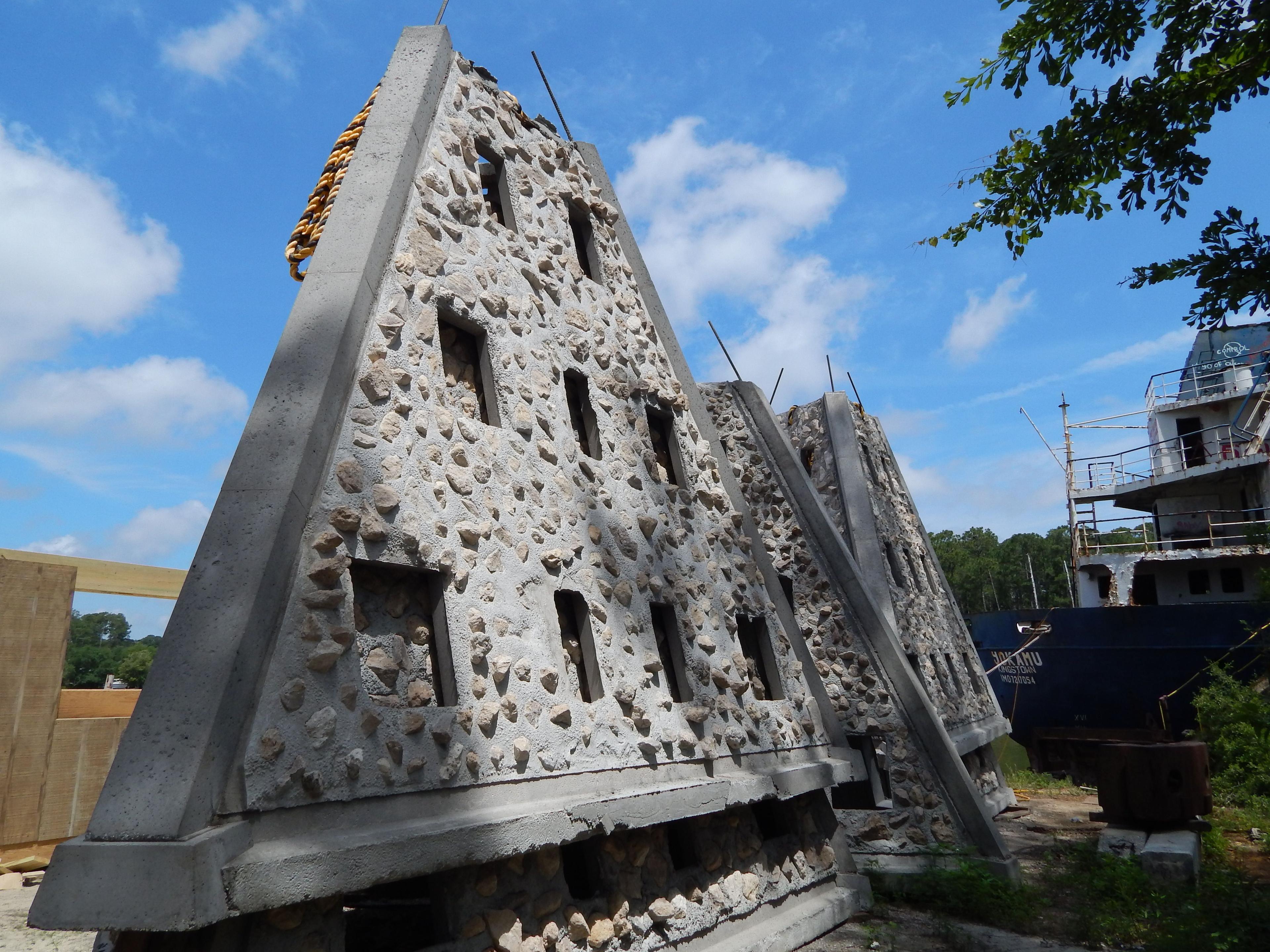 Low-angle view of a Super Reef module with limestone embedded in its concrete surfaces