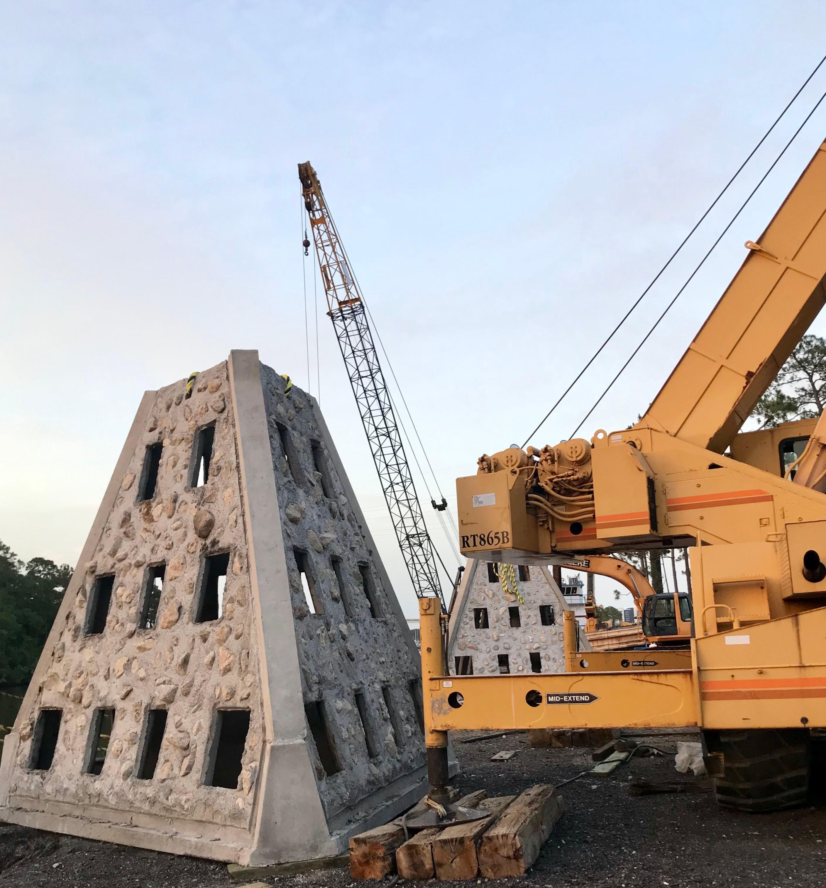Large Super Reef module positioned beside a mobile crane during onshore handling