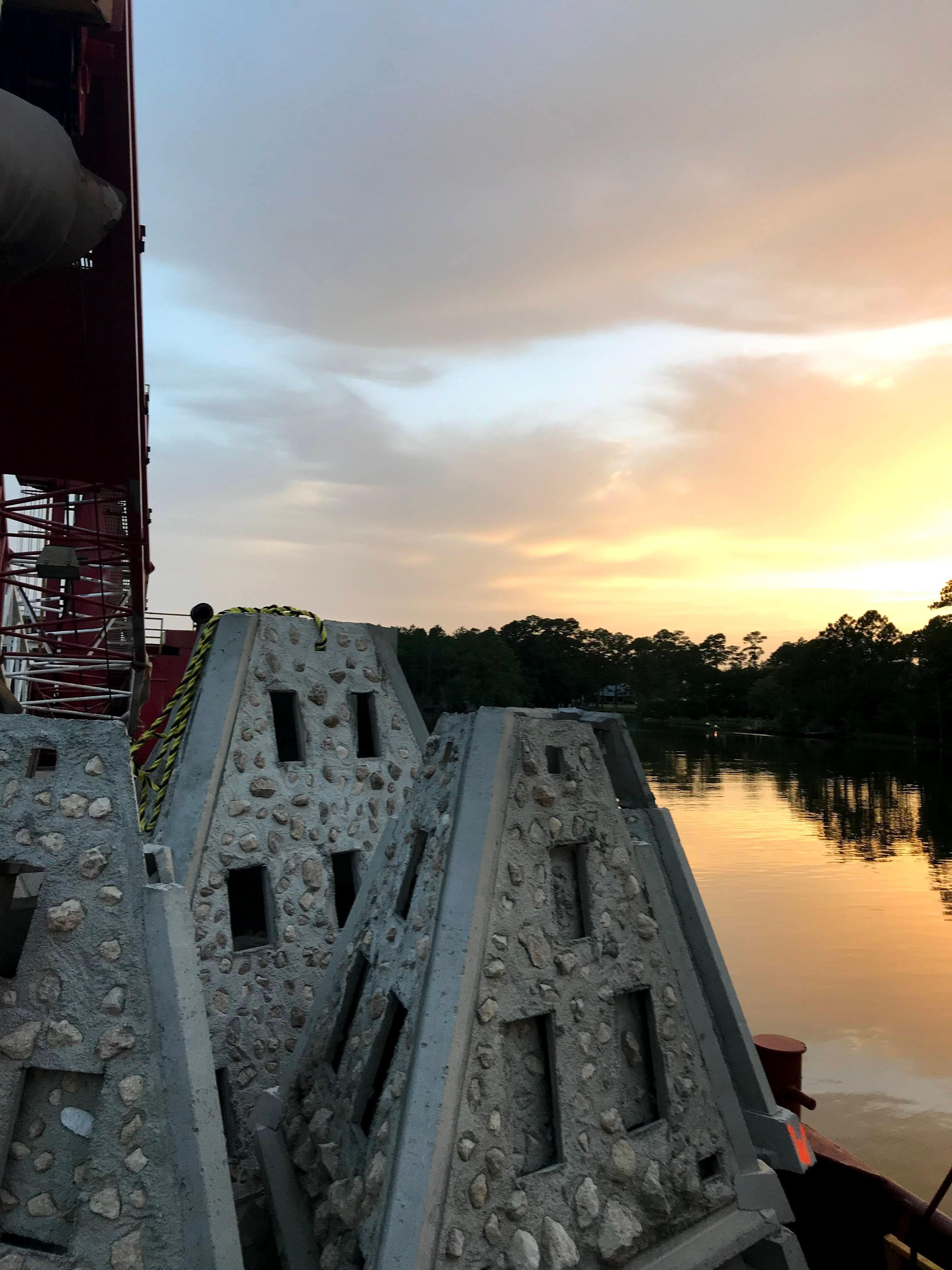 Rows of pyramid-shaped concrete reef modules at sunset