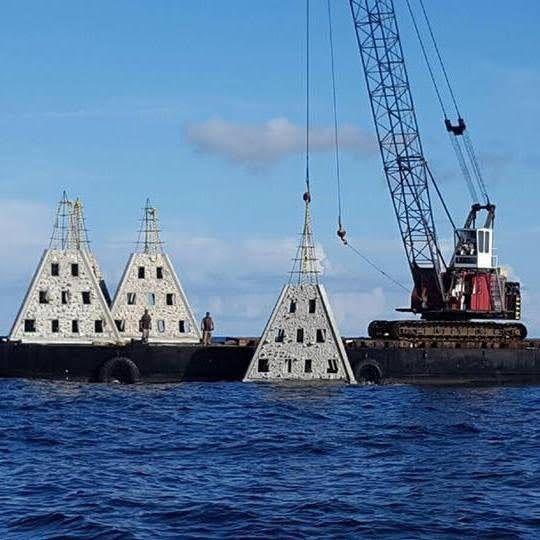 Pyramid reef modules staged on a marine construction barge