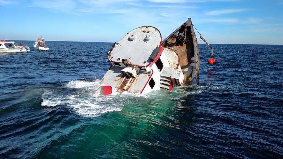 Vessel listing heavily during a controlled artificial reef sinking